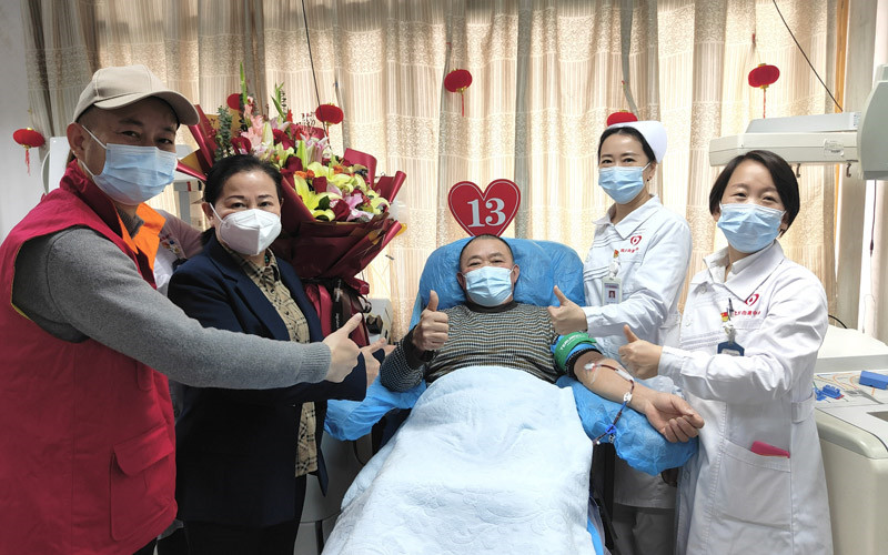 武漢血液中心工作人員為李光明（中）送上祝福。