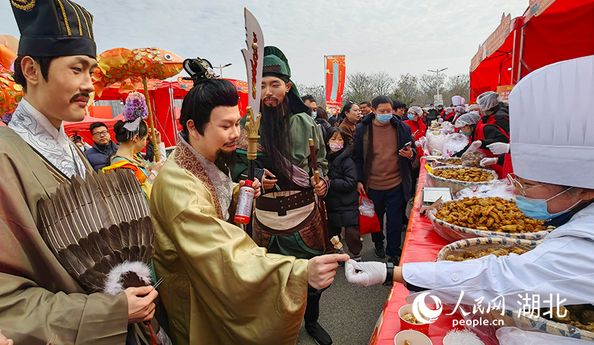 工作人員打扮成三國人物品嘗武漢特色炸肉圓。人民網(wǎng)記者 郭婷婷攝