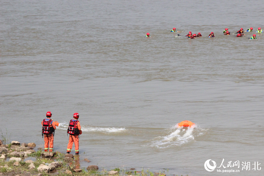 在岸邊操作水面救生艇，駛向被困人員。人民網(wǎng)記者 張沛攝